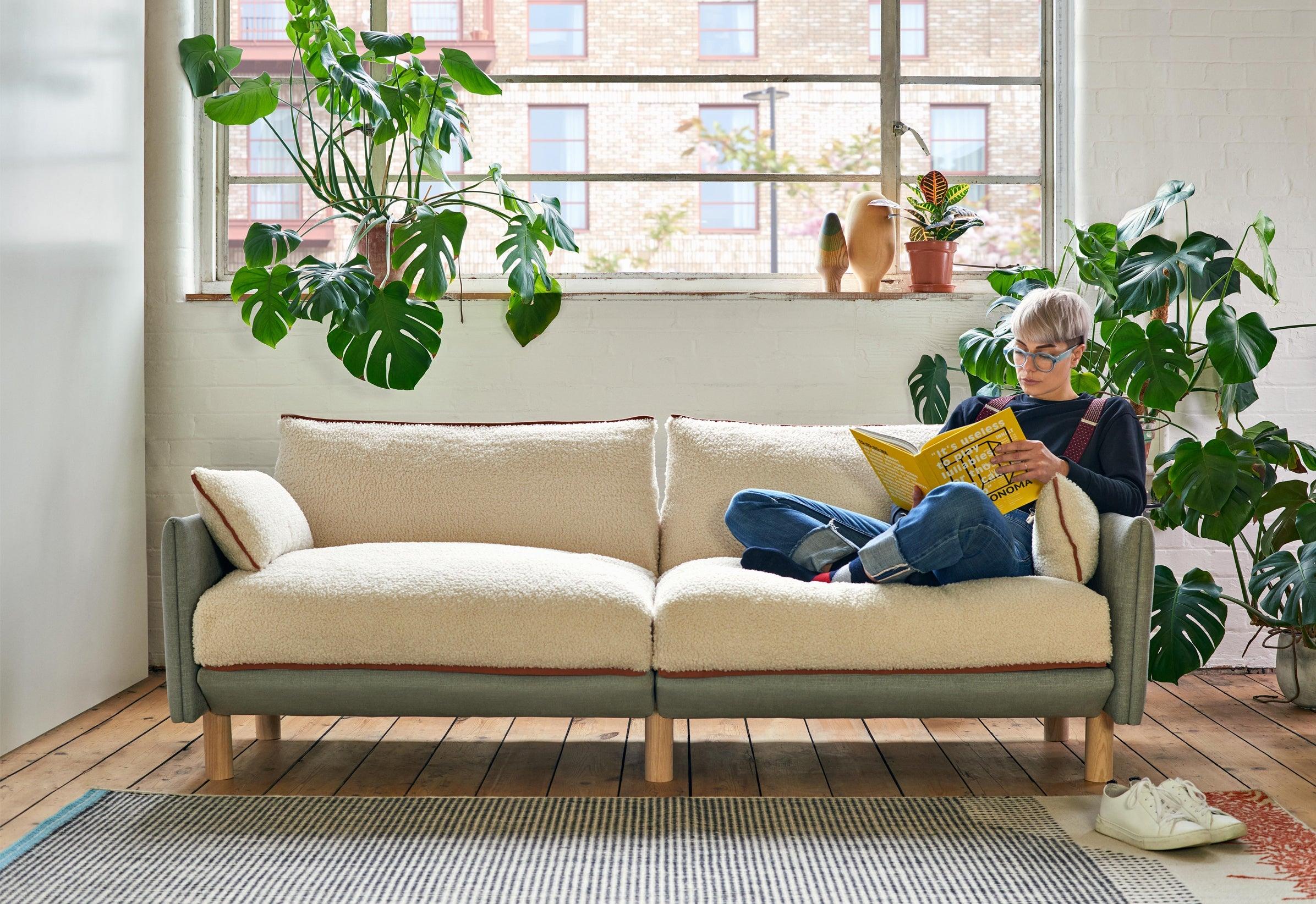 3 Seater Cozmo Sofa Weave Light Gray with Fleece Cream Jacket while someone sits and reads @ Light Grey Weave Jacket | Natural Trim